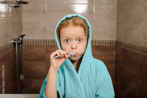 dental hygiene. happy little girl brushing her teeth photo