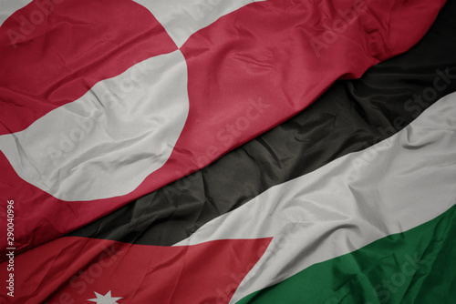 waving colorful flag of jordan and national flag of greenland.