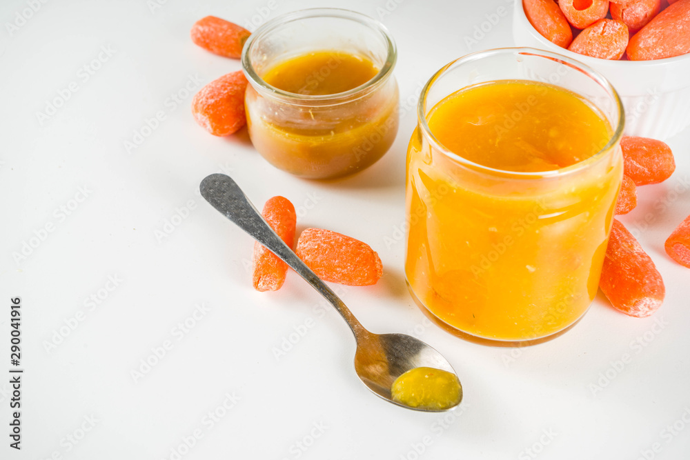 Homemade carrot jam with fresh baby carrots, copy space Homemade carrot jam with fresh baby carrots, copy space