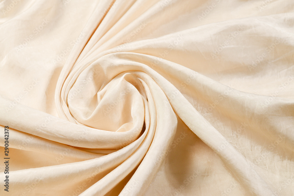 Soft smooth beige silk fabric background. Fabric texture. Soft smooth beige silk fabric background. Fabric texture.