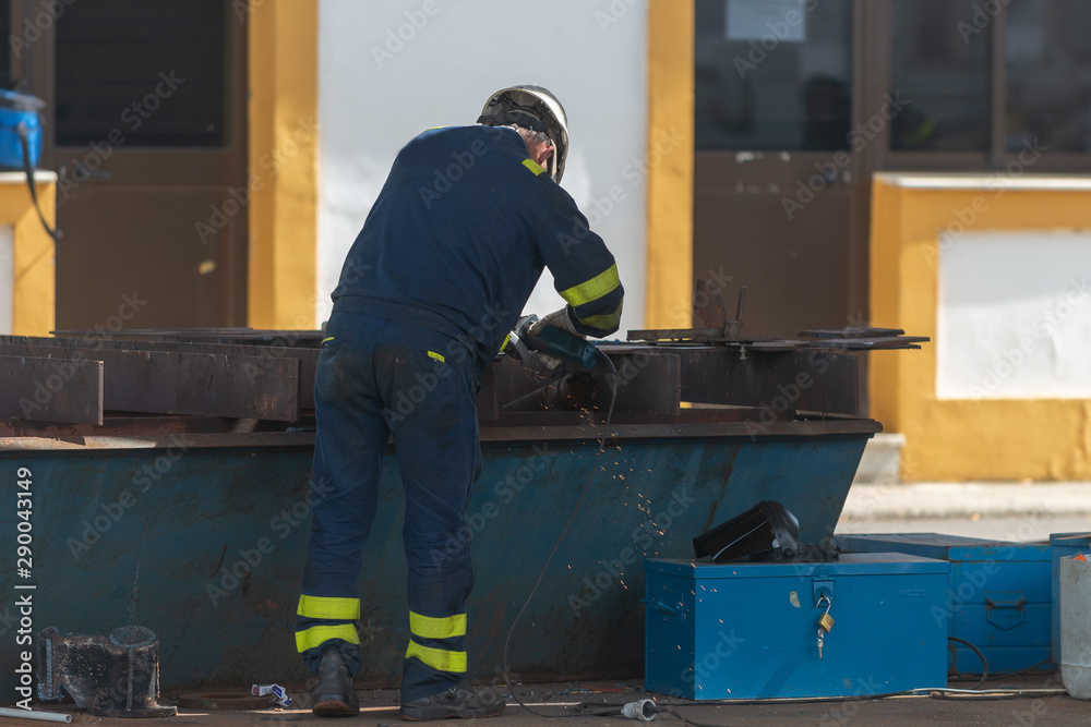 Worker working on ship repairing yard Worker working on ship repairing yard