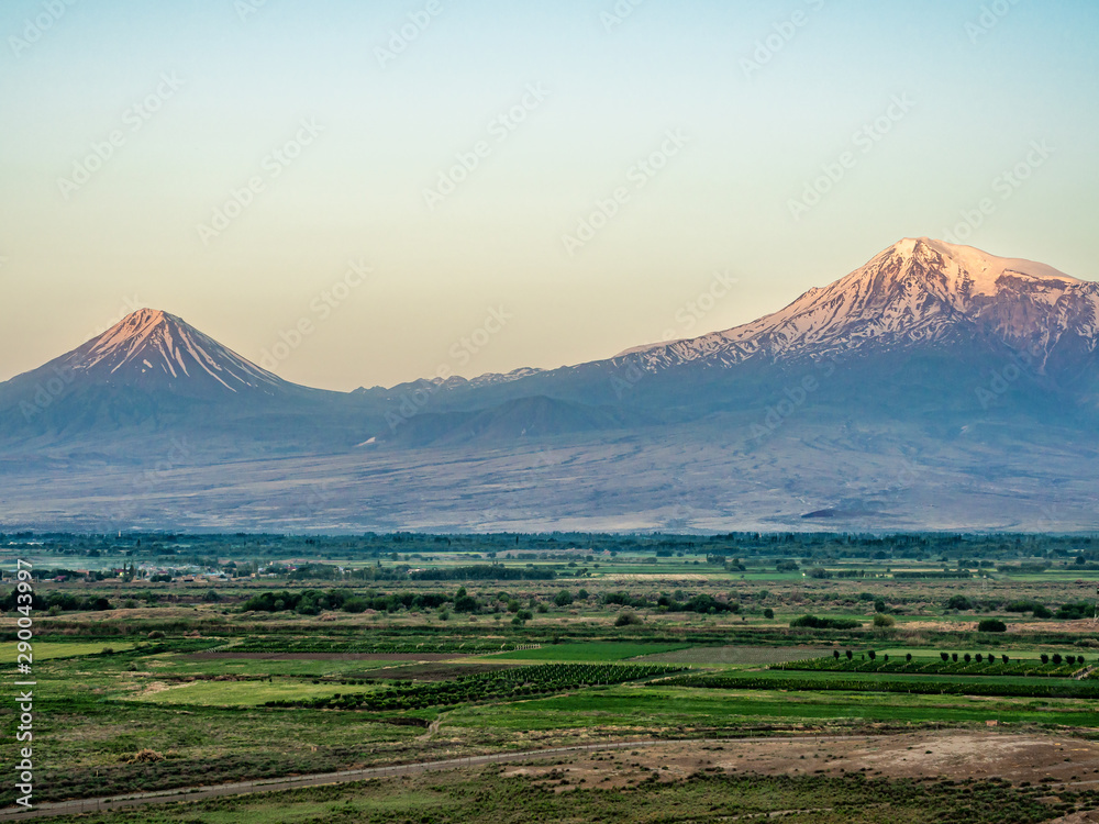 First rays of the sun illuminate peaks of Mount Ararat