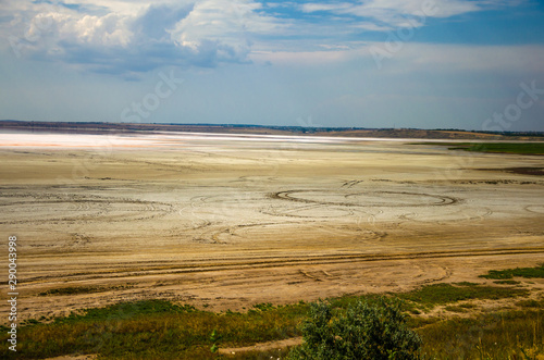 Dried salt lake.Car tracks at the bottom of the former lake.