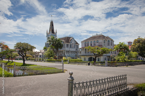 Ancient, fabulous building with a spire and towers, in the Gothic style. Guyana attractions, architecture style tradition.
