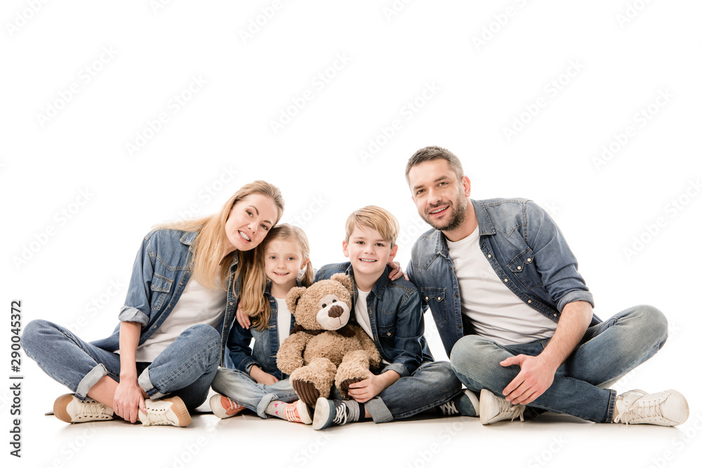 happy family in jeans with teddy bear sitting isolated on white happy family in jeans with teddy bear sitting isolated on white
