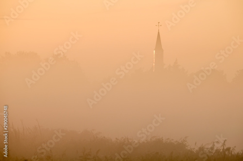 Fog covered village view at sunrise
