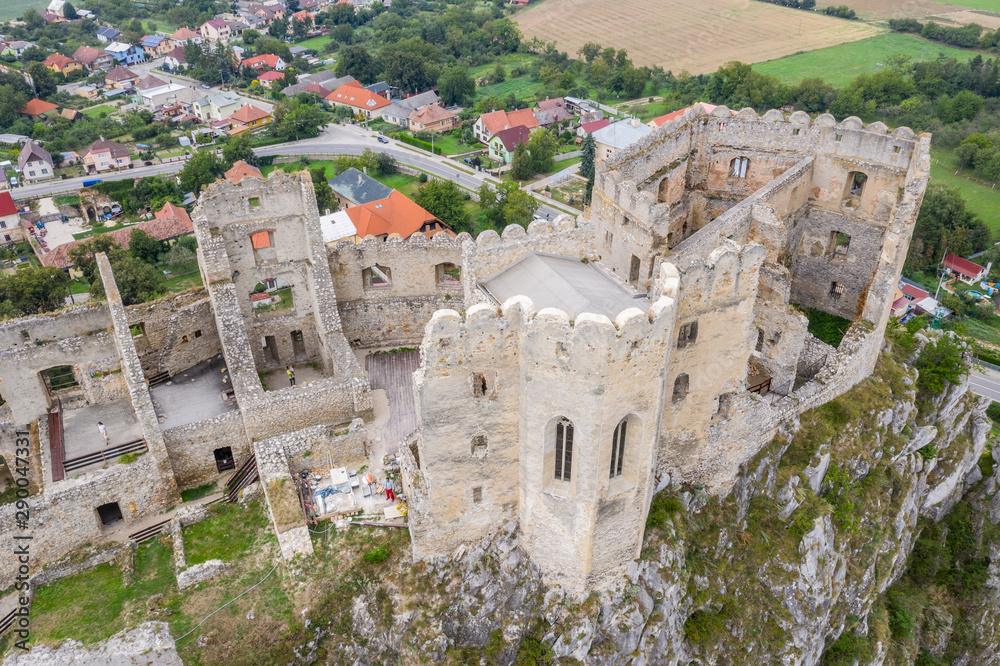 Aerial view of Beckov castle with restored Gothic chapel in Slovakia above the Vah river