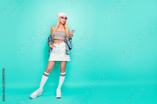 Full length body size view of nice-looking attractive lovely feminine slim fit thin slender content straight-haired girl chatting online isolated on bright vivid shine green turquoise background