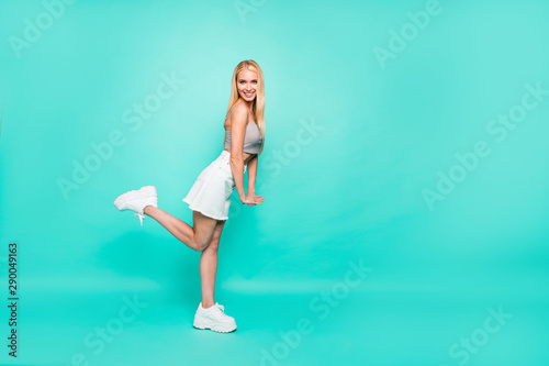Full length body size profile side view of her she nice attractive lovely lovable cheerful cheery straight-haired girl having fun posing isolated on bright vivid shine green blue turquoise background