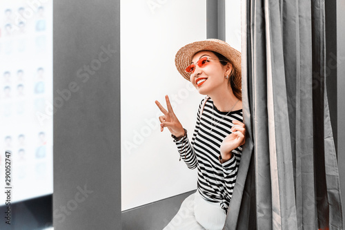 Asian girl having fun and making faces in the photo booth. The concept of small business in the field of photo printing photo