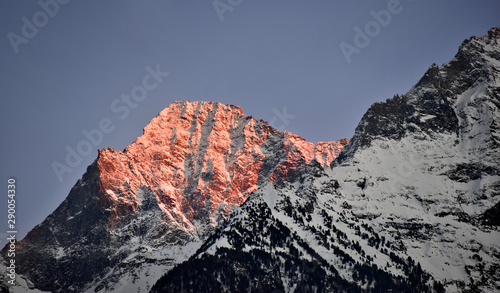 Sunset on the mountains: the snow capped peak turns red as it catches the last light of the day. Italian Alps in the Aosta Valley. © Niccolo