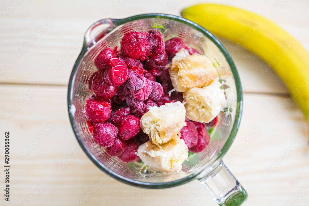Mixed Spinach with Cherry and Banana in a Blender, Smoothie Preparation Process, Top View, Free Space for Text Mixed Spinach with Cherry and Banana in a Blender, Smoothie Preparation Process, Top View, Free Space for Text