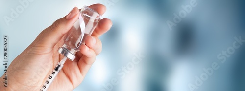 Human Hand with injection Syringe on light background photo