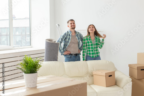 Family, new apartment and relocation concept - Young couple moving in new house