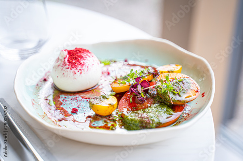 Burrata Cheese Salad with Tomatoes, Basil Leaves, Balsamic Cream Sauce in Luxury Restaurant, Healthy Food Concept