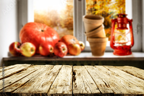 blurred autumn window background and desk of free space for your decoration. 