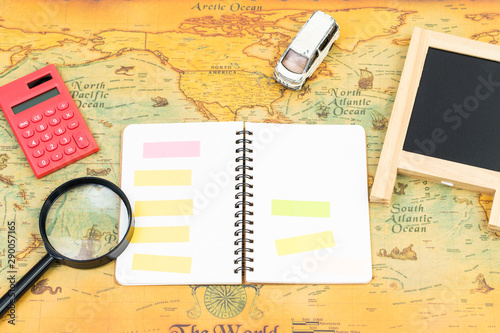 Blank notebook with accessory on world map. travel business concept