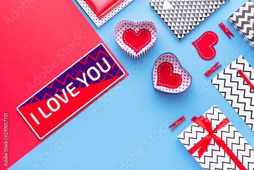 Person holding a present for Saint Valentine's day in his hands. Beautiful colorful background to st. Valentine day. Greeting card with red hearts. Wedding's invitation. Love expression.