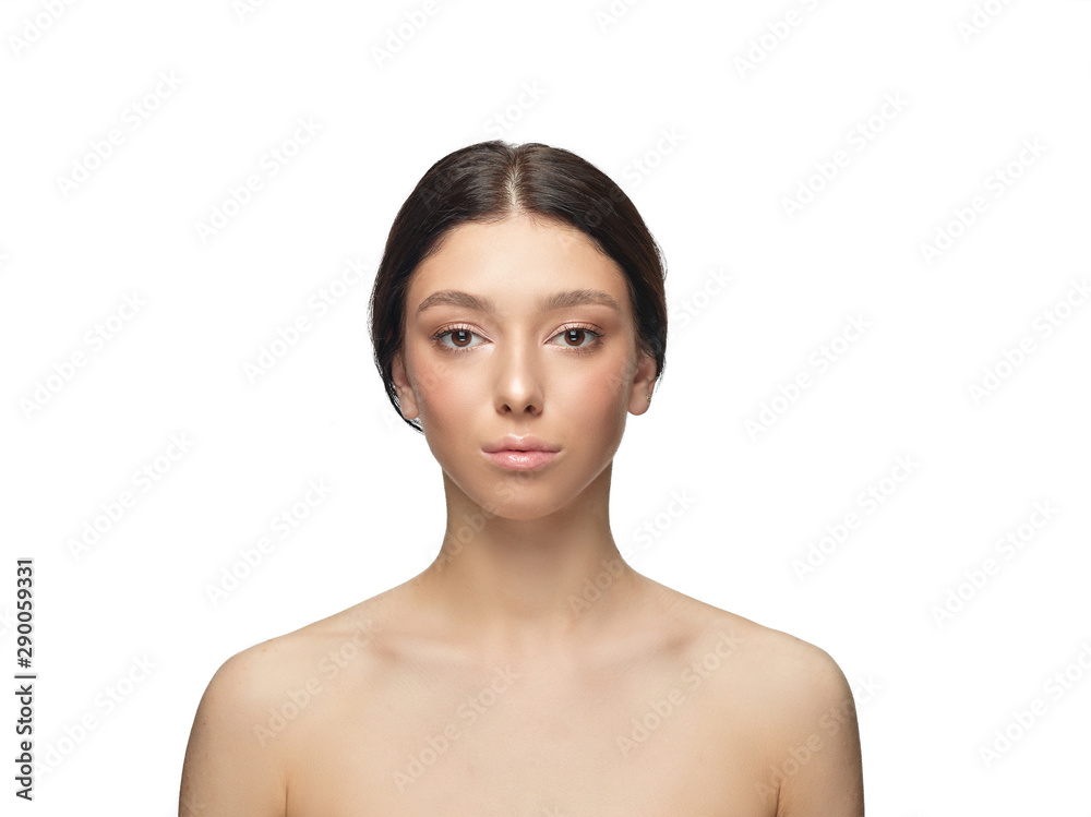 Portrait of beautiful young woman isolated on white studio background. Caucasian healthy female model looking at camera and posing. Concept of women's health and beauty, self-care, body and skin care. Portrait of beautiful young woman isolated on white studio background. Caucasian healthy female model looking at camera and posing. Concept of women's health and beauty, self-care, body and skin care.