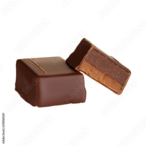 Cut luxury handmade chocolate candy with ganache and salt caramel filling isolated on white background