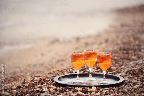 Glasses with a gazirvoannim refreshing drink on the beach among small pebbles. photo