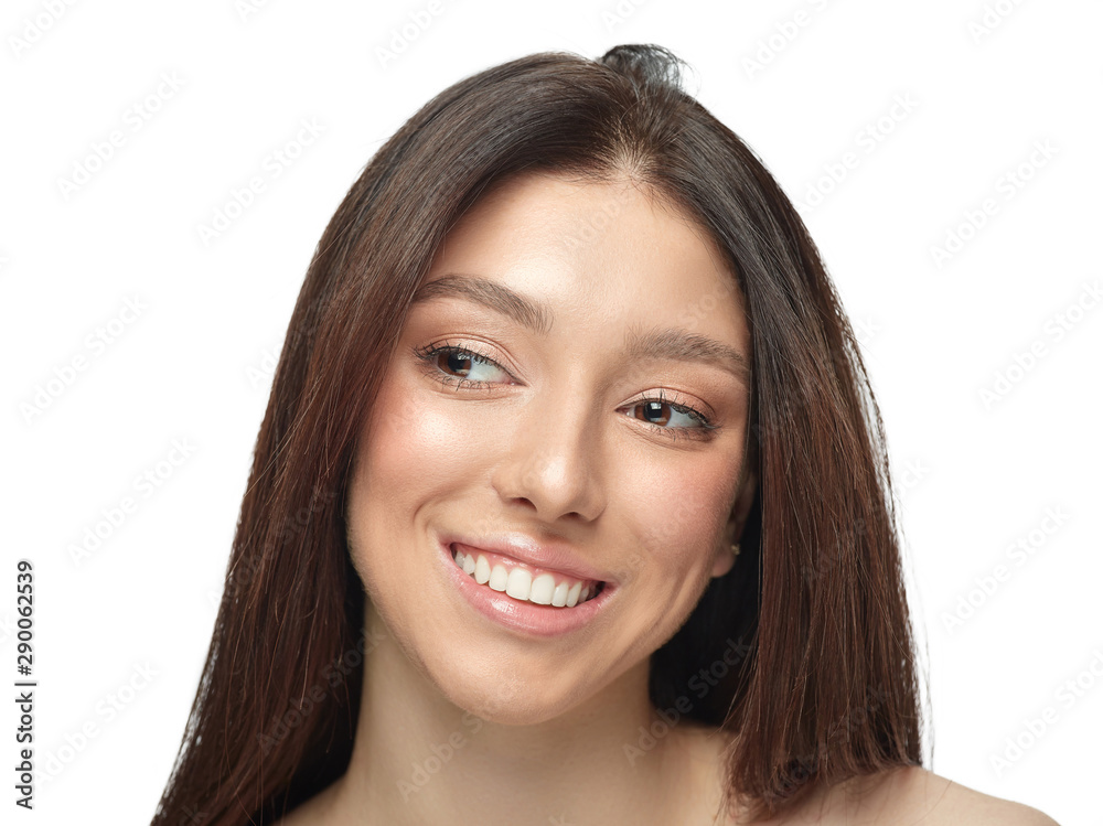 Portrait of beautiful young woman isolated on white studio background. Caucasian healthy female model looking at side, smiles pretty. Concept of women's health and beauty, self-care, body, skin care. Portrait of beautiful young woman isolated on white studio background. Caucasian healthy female model looking at side, smiles pretty. Concept of women's health and beauty, self-care, body, skin care.
