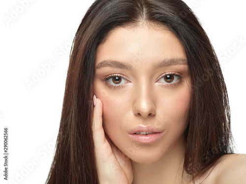 Portrait of beautiful young woman isolated on white studio background. Caucasian healthy female model looking at camera and posing. Concept of women's health and beauty, self-care, body and skin care.
