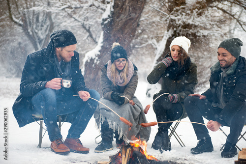 Friends having barbecue on a snowy day