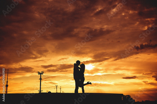 couple love passion hugs outside sunset kiss