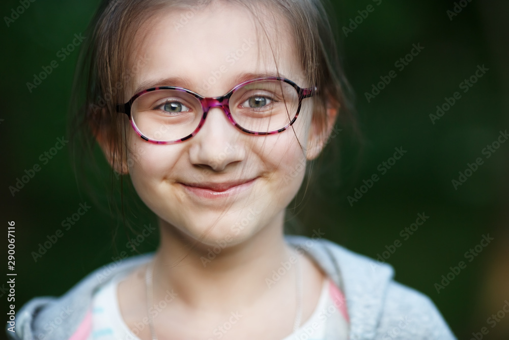 Happy smiling child girl in glasses. Selective focus. Happy smiling child girl in glasses. Selective focus.