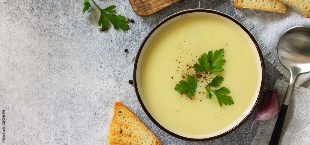 Vegetarian dish. Dietary Tasty Summer cream soup Zucchini on a light background. Top view flat lay. Free space for your text. Banner. Vegetarian dish. Dietary Tasty Summer cream soup Zucchini on a light background. Top view flat lay. Free space for your text. Banner.