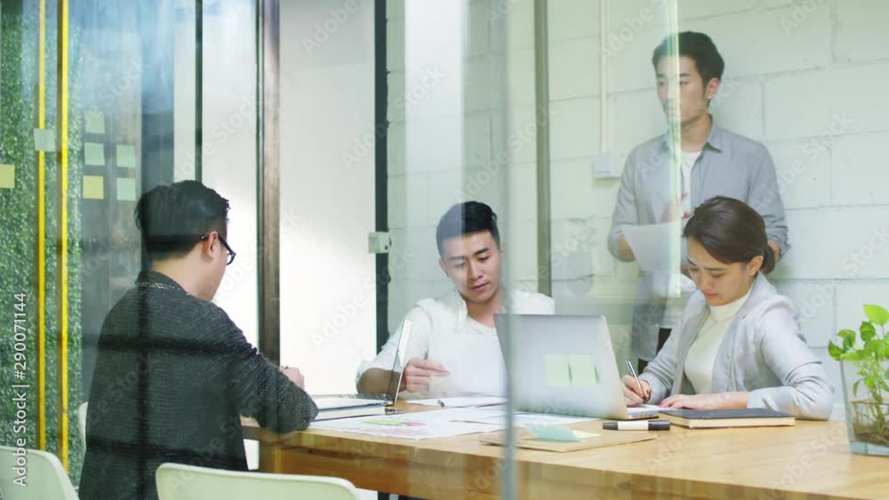 group of young asian entrepreneurs discussing business in company meeting room group of young asian entrepreneurs discussing business in company meeting room