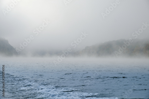 Fog thick fog on the lake in Bashkortostan Republic in the fall. Mist Lake mountains