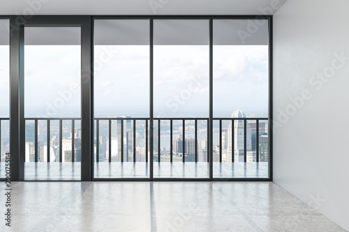 Empty modern spacious hall with concrete floor, big window with city view in the afternoon.