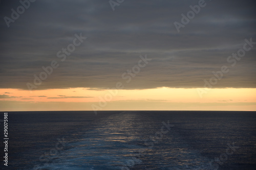 Sunset over the sea  view from the sailing cargo ship.