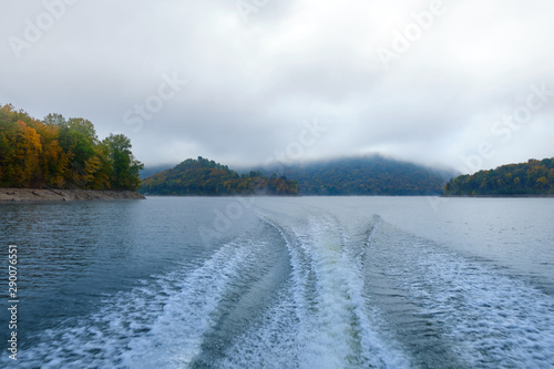 Wallpaper Mural The trail of the boat (Wake) on the lake in the middle of the mountains and fog in the autumn. Boat trip on the lake in autumn in Alaska Torontodigital.ca