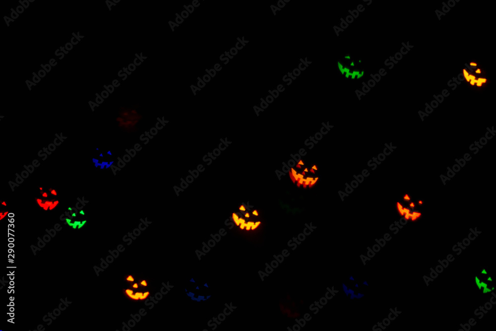 Festive Halloween  background with natural bokeh in shape of Halloween emoticons and bright lights. Party background.