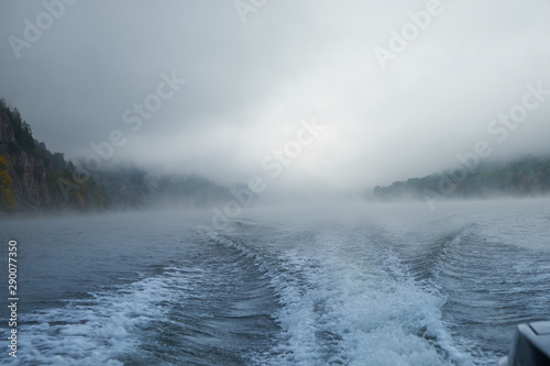 Walk on the Norwegian lake on a boat in the autumn in the fog. Wake of the boat © Eduard Vladimirovich