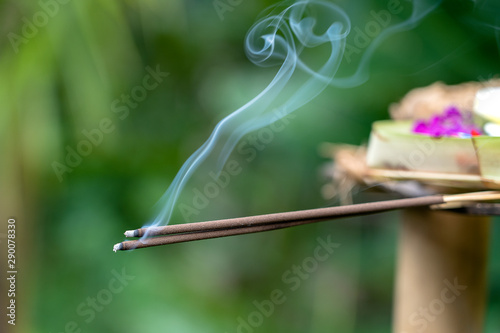 Incense stick burning with smoke, closeup . Island Bali, Ubud, Indonesia