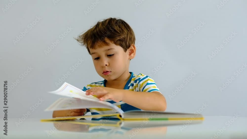 slow motion asian kid reading book in living room. Having fun and excited or interested book stories with happiness smiling, laughing face. slow motion asian kid reading book in living room. Having fun and excited or interested book stories with happiness smiling, laughing face.