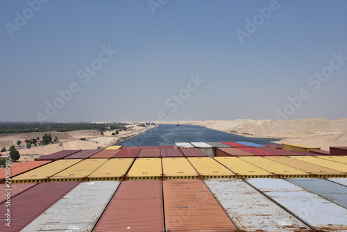 Cargo container ship transiting through the Suez Canal  view from the navigational bridge on the deck loaded with containers