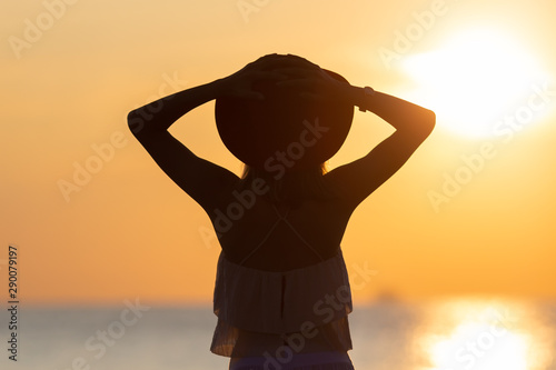 Sunset Reverie: Woman's Silhouette with a Stylish Hat
