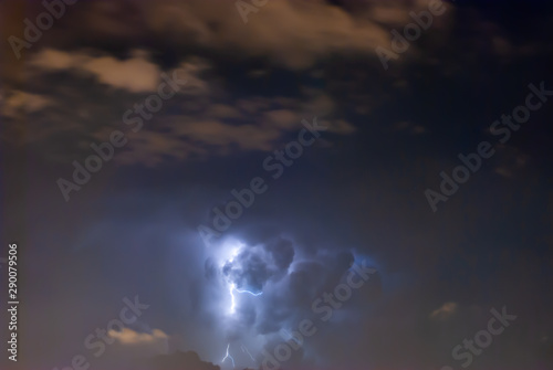 Powerful Lightning bolts strike in the stormy weather sky.