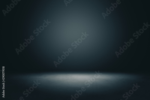 Abstract blank dark wall with copyspace and dark stage with spot light from above in empty hall.