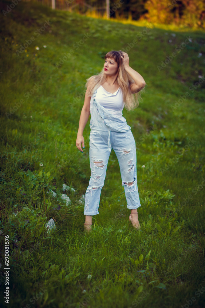 portrait of a young woman in overalls with long hair portrait of a young woman in overalls with long hair