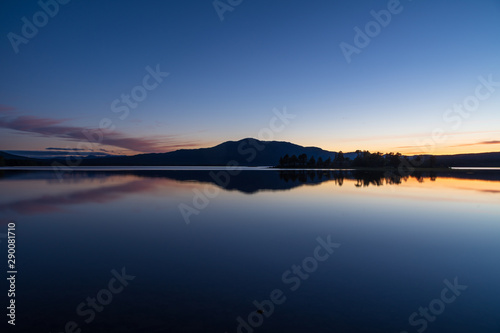 Tranquil dusk reflected in a lake in scandinavia. Ottsjon  Sweden.