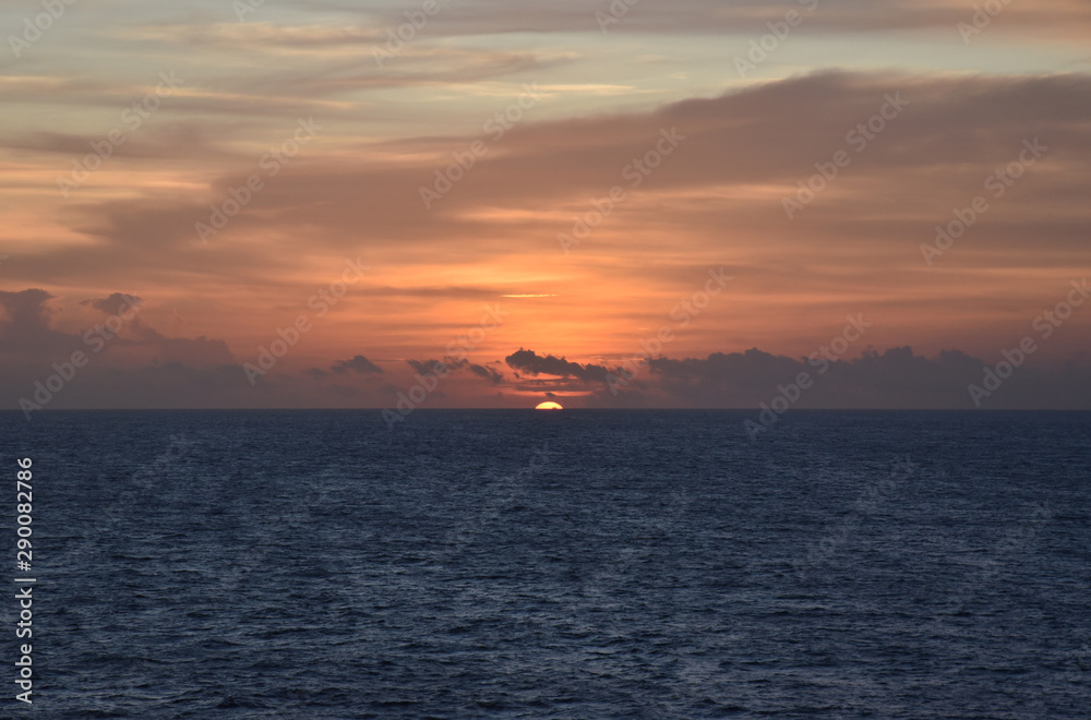 Fototapeta premium Sunset over the sea, view from the sailing ship.