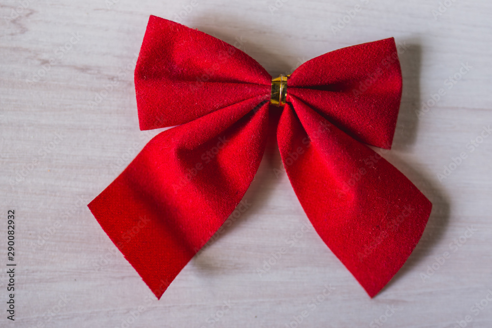 red bow and ribbon on wooden background red bow and ribbon on wooden background