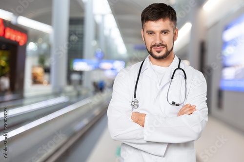 Young beautiful nurse on blurred hospital background