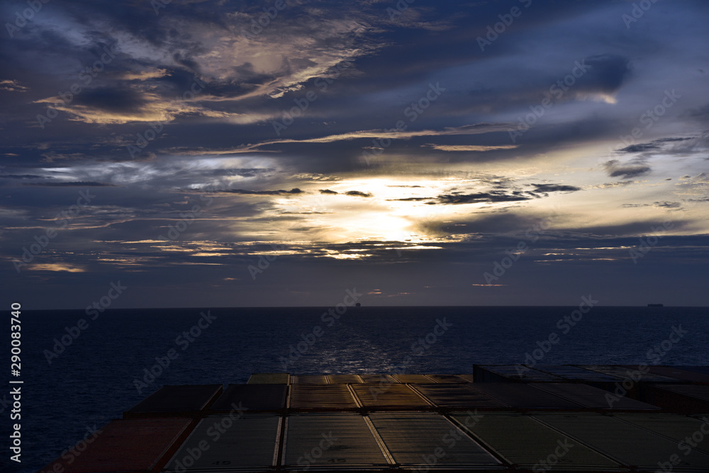 Sunset over the sea, view from the sailing ship.